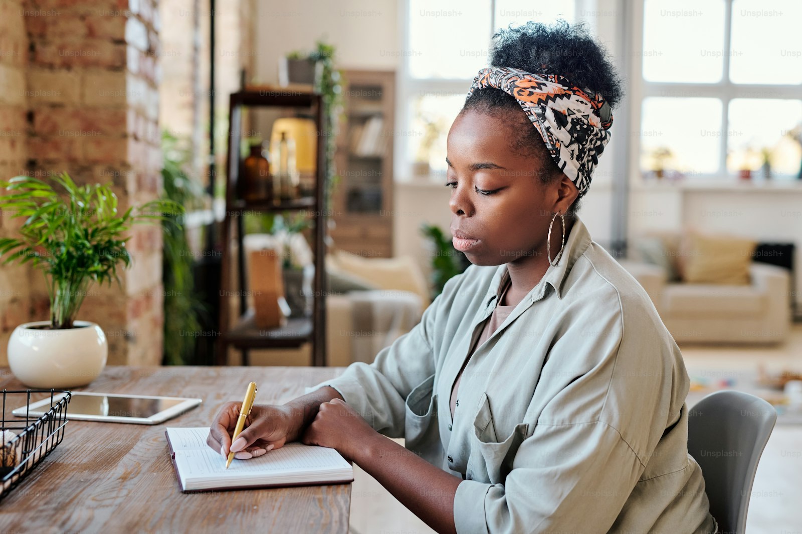 A woman writing an education and career plan in her notebook